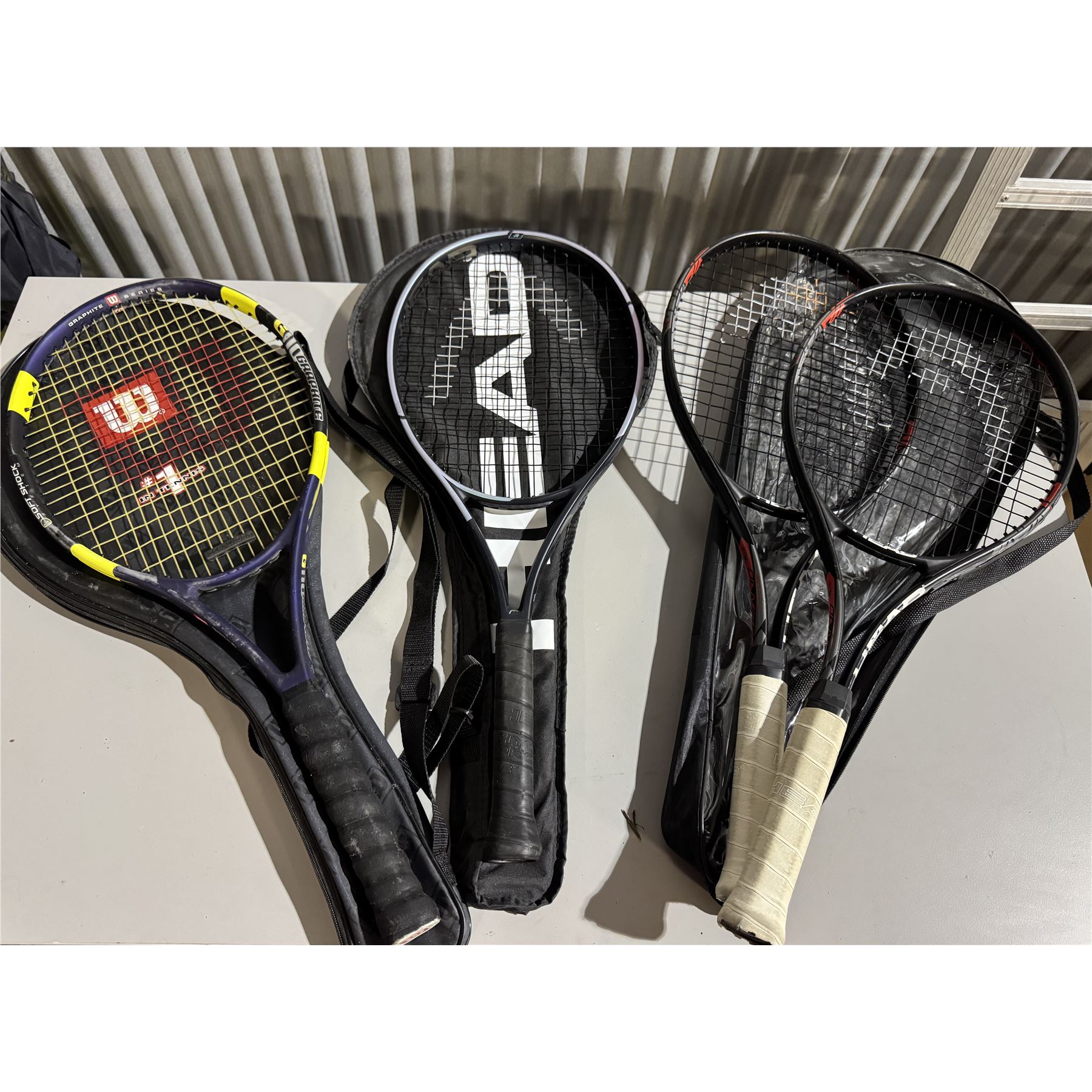 Four tennis rackets and bags