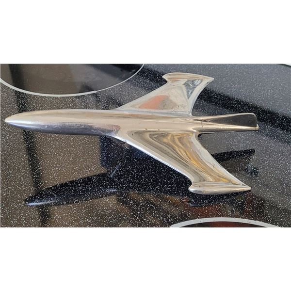 Die cast jetplane hood ornament 9 1/2" long, mirrors surrounding colours, looks stainless
