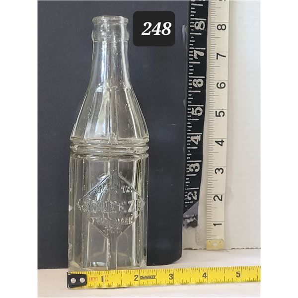 Vintage embossed Squeeze soda bottle.