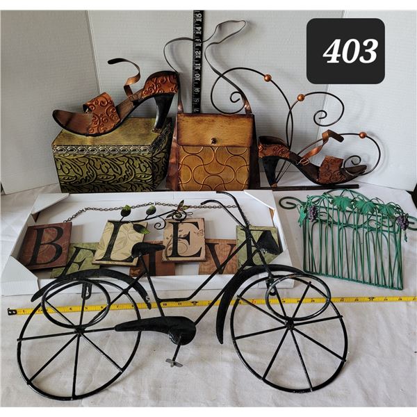 Group of metal wall art including metal bicycle plant pot holder.