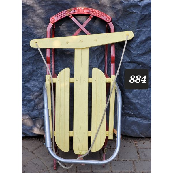 Mid century wood sled with metal rails.