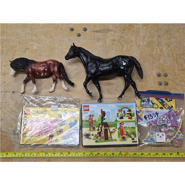 2 plastic horses and legos