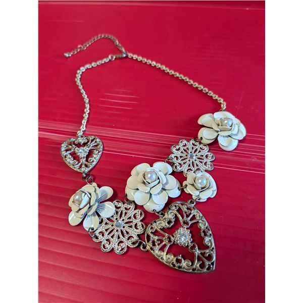 White metal floral choker with imitation pearl accents and a dangling chain.