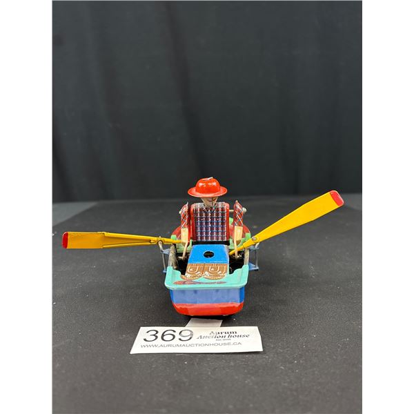 Vintage wind up tin toy man in rowboat