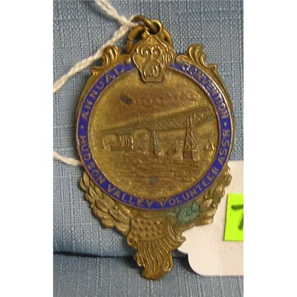 Antique brass and blue enameled badge