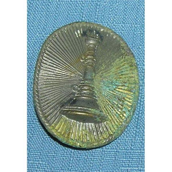 Early raised fire trumpet badge