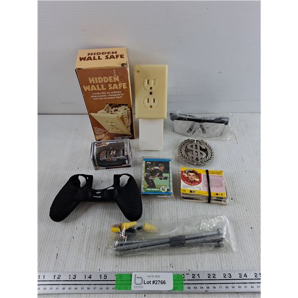 Hidden Wall Safe, Dollar Sign Belt Bucket, Various Hockey Cards, Safety Goggles, Misc