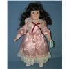 Porcelain doll in pink dress with glass eyes