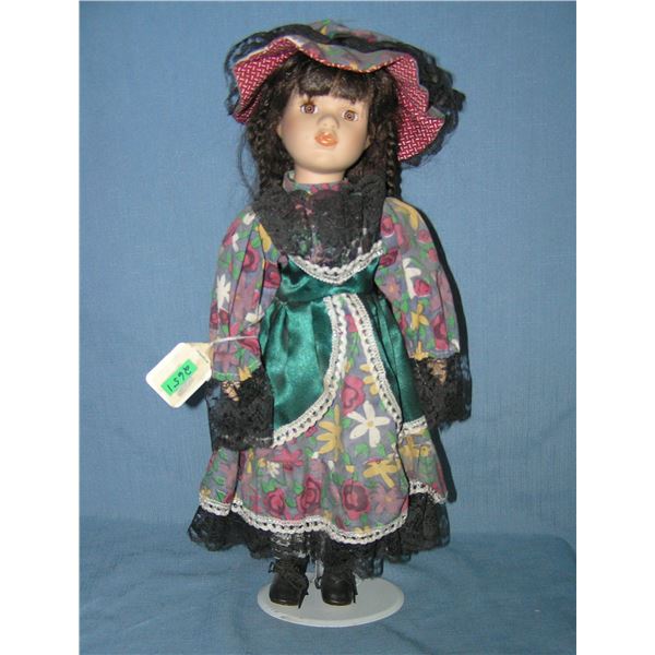 Porcelain doll with fancy dress and hat