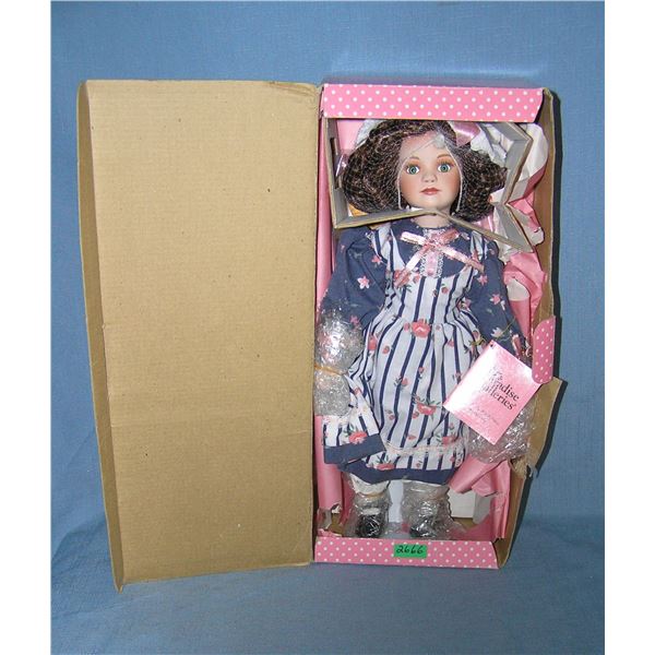 Porcelain doll with fancy dress and hat