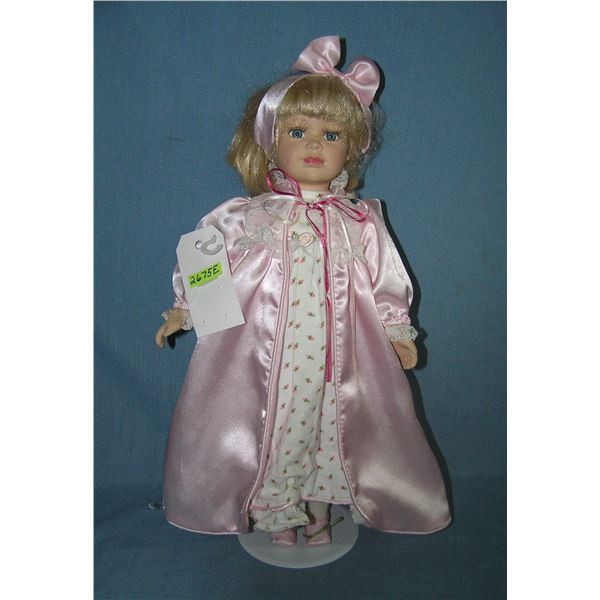 Porcelain doll with pajamas and pink night gown