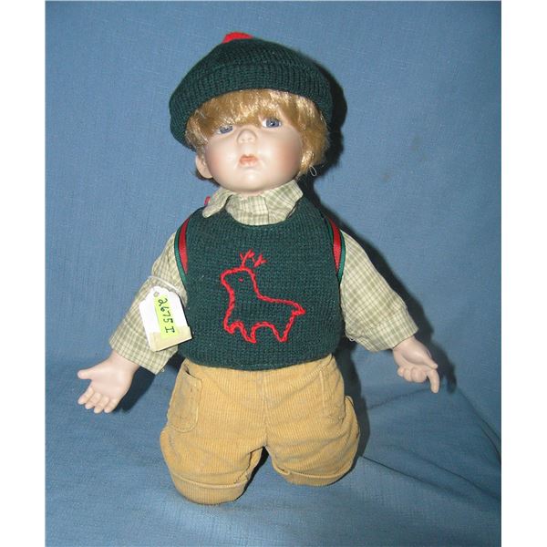 Porcelain boy doll with back pack and hat