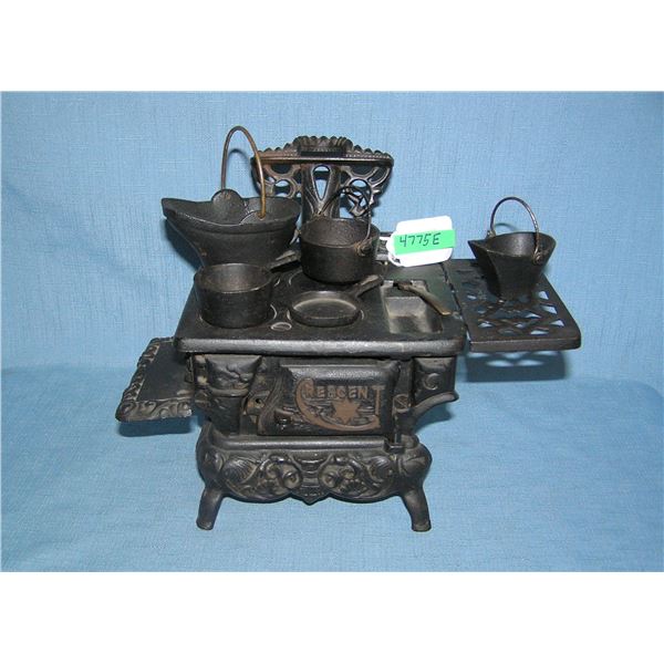 Cast iron Crescent child's stove loaded with cast iron accessories