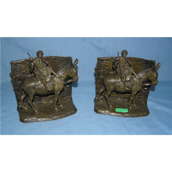 Pair of signed bronze Arabian figures riding a donkey