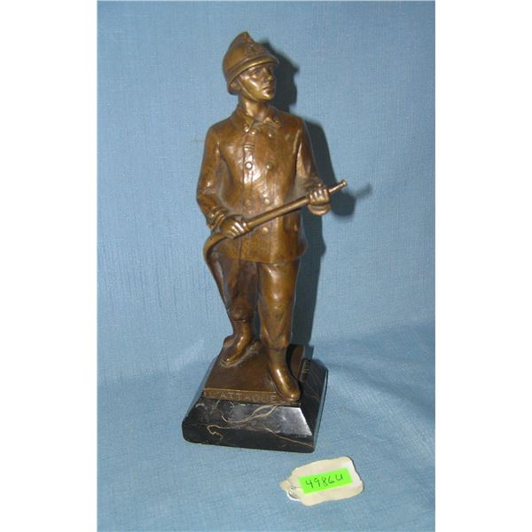 Early bronze fireman on a marble base