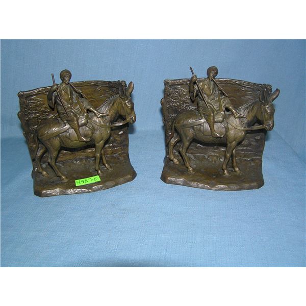 Pair of signed bronze Arabian figures riding a donkey