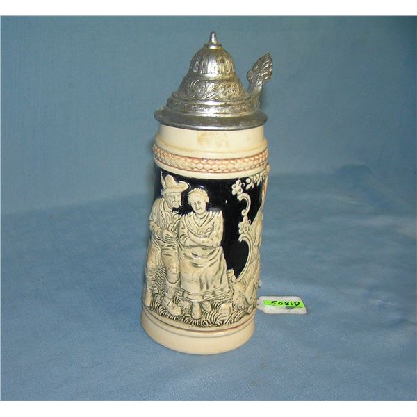 Vintage German beer stein features a couple on front