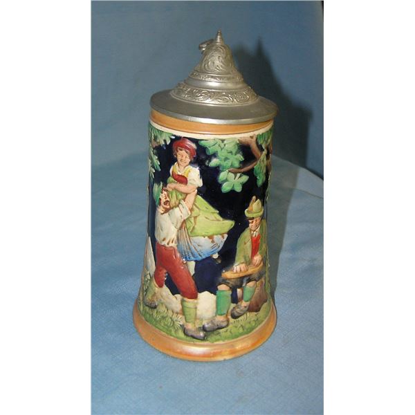 Vintage German beer stein features festive group of 3