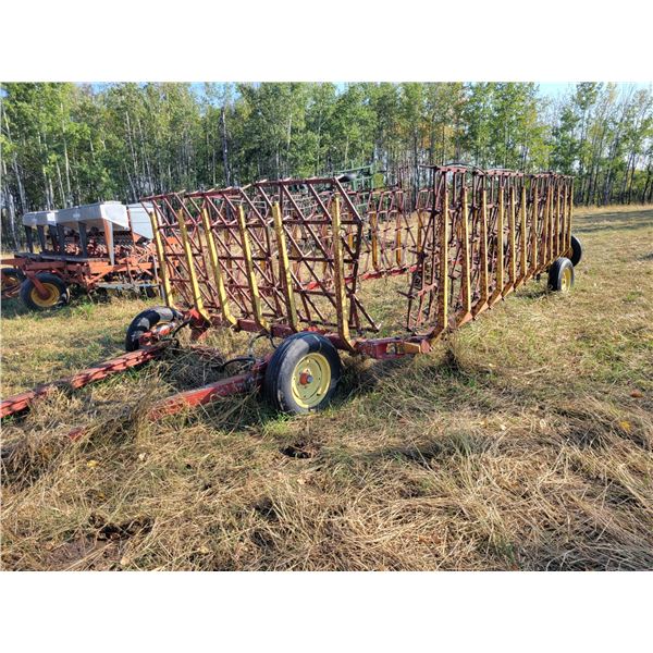 Farm King 50 ft harrow bar, 42 inch harrows, hyd. Lift, good condition