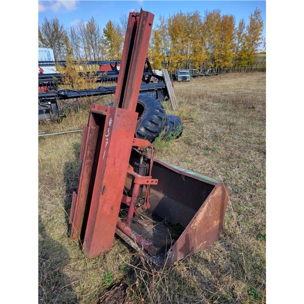 Jet post pounder mounted on JD 148 loader bucket