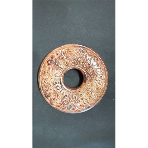 A MOTTLED YELLOW CELADON PRAYER DISC