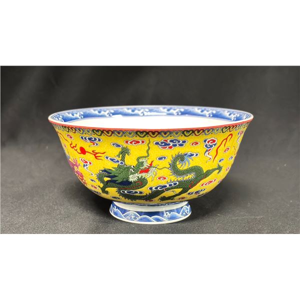 A YELLOW GROUND FAMILLE ROSE DRAGON BOWL
