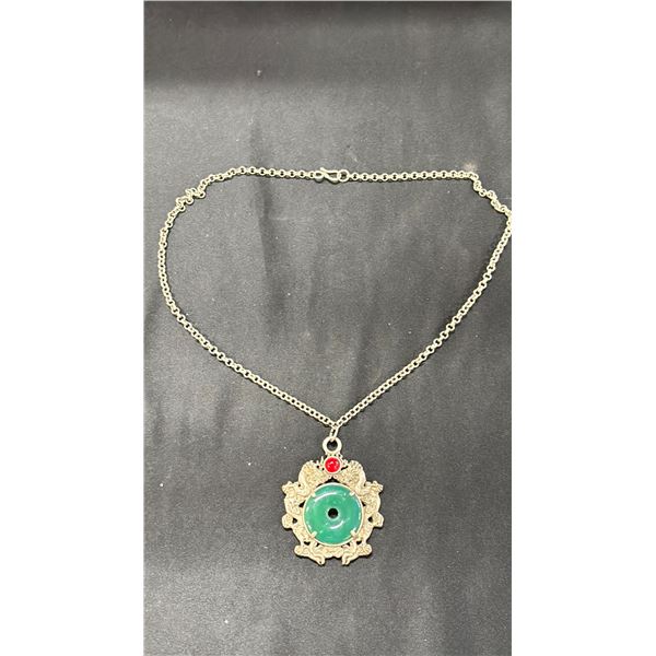 A NEPAL SPINACH GREEN DISC DRAGON PENDANT