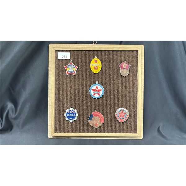 A FRAMED CHINESE WAR BADGES