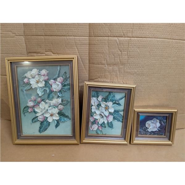 Three framed paper mache pictures.