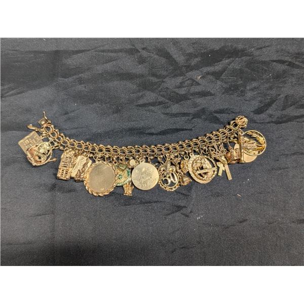 1345:  14 kt gold bracelet with 28 gold charms, mixture of 12 kt, 14 kt and unknown charms. Weight: 