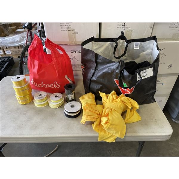 LOT OF BLACK AND YELLOW WRAPPING PAPER ROLLS, FABRIC, AND BAG OF RIBBON
