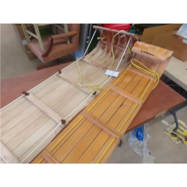 2 wooden snow sleds, largest is 74x16
