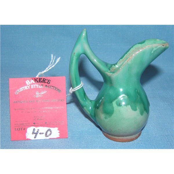Artist signed glazed over earthenware pitcher