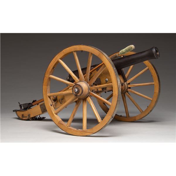 MINIATURE STEEL CANNON WITH CARRIAGE.