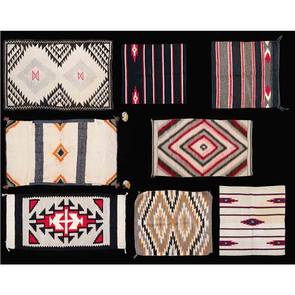 GROUPING OF 8 NAVAJO THEMED RUGS.
