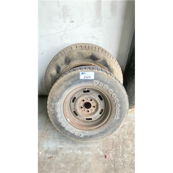 A FIRESTONE P225/70R14 WHEEL AND TIRE WITH A MICHELIN P245/70R17 WHEEL AND TIRE