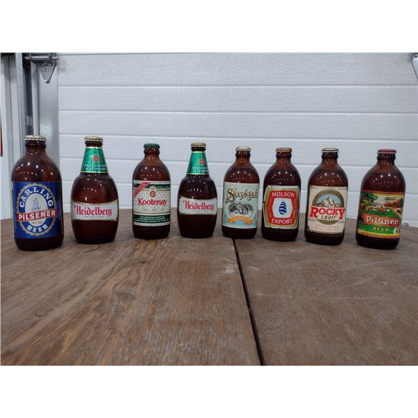 9 full/sealed stubby beer bottles