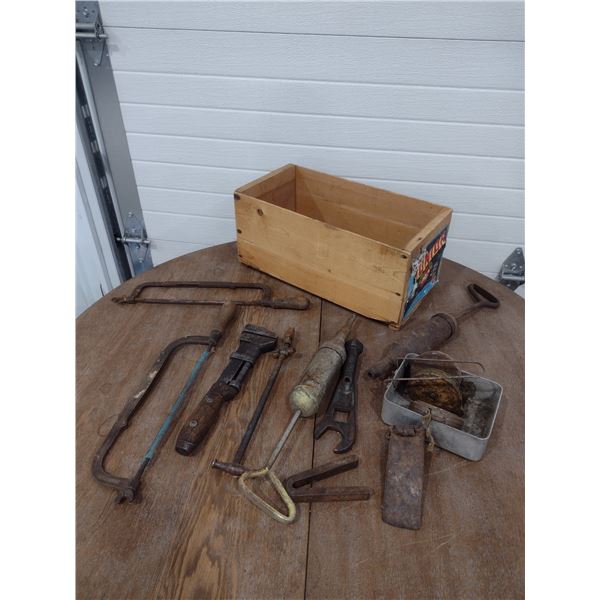 assortment of antique tools in wood crate