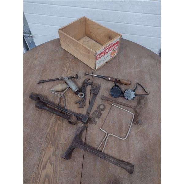 assortment of antique hand tools in wood crate