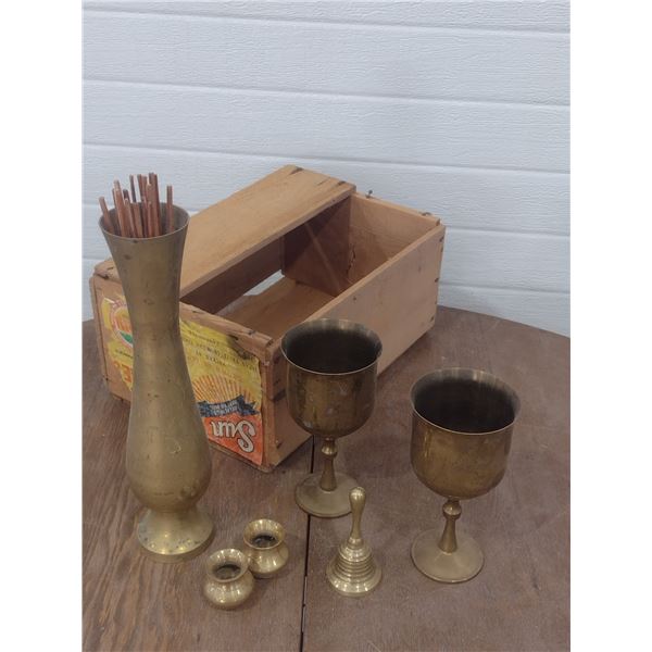 assortment of brass ornaments with small wood crate