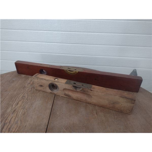 two wooden carpenter levels