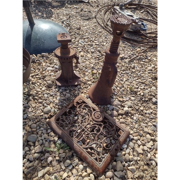 2 screw jacks and a cast iron grate