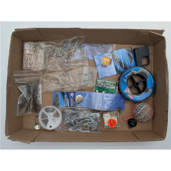Assortment of fishing hooks, weights, line etc.
