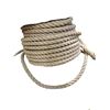 Image 2 : A large, wooden spool wrapped with thick, braided natural fiber rope.