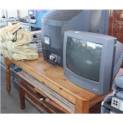 Table of items including televisions, cot, bench