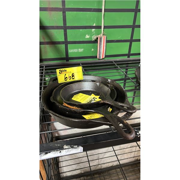 THREE CAST IRON PANS