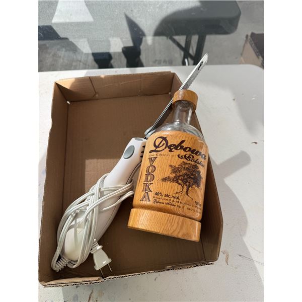 Electric knife and vodka bottle