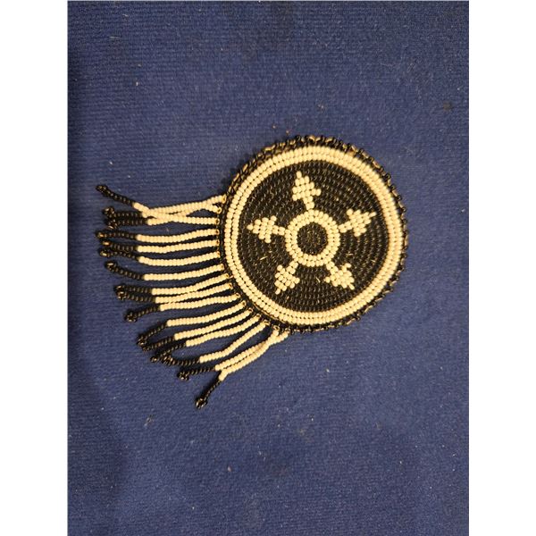 Beaded brooch with leather back