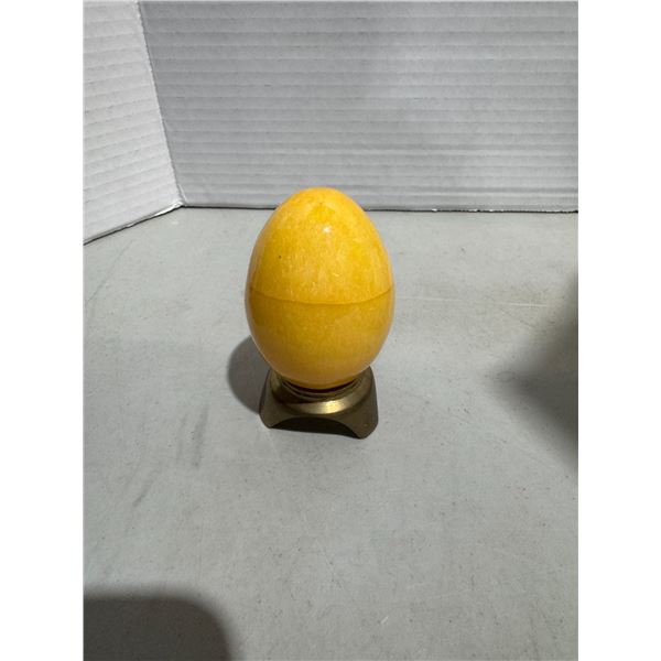 Orange calcite crystal egg with breast stand