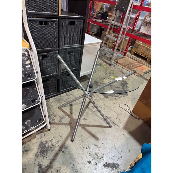 Glass top table with folding pedestal